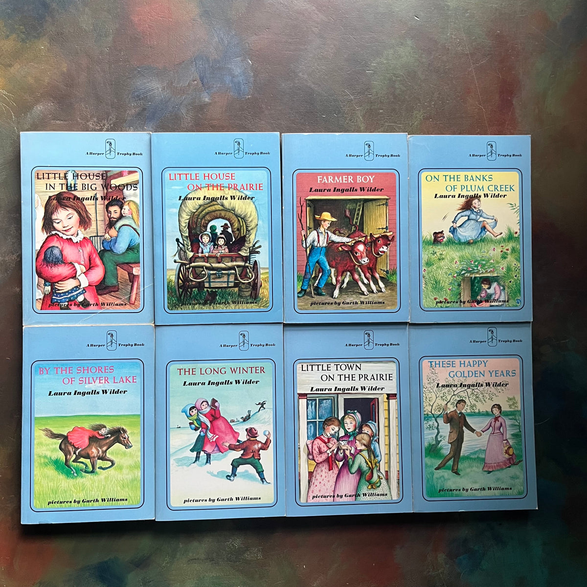 Little House on the Prairie Blue Cover Collection written by Laura Ingalls Wilder with illustrations by Garth Williams - 1970's paperbacks-view of the front cover each depicting a scene from the book
