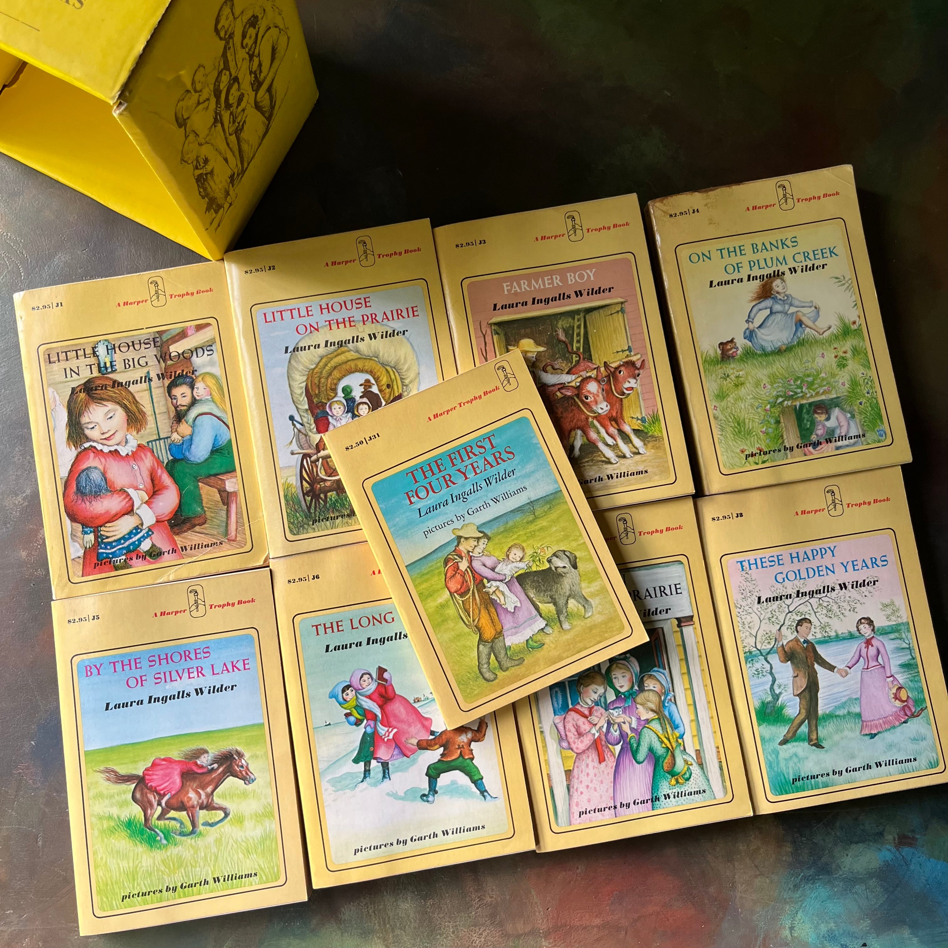Set of books titled 'Little House on the Prairie' in a yellow box-Award-winning children's books-Laura Ingalls Wilder-view of the front covers