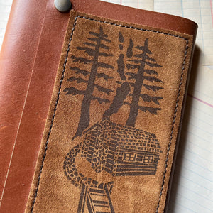 Log Cabin Leather Journal or Guest Book, nature, gratitude or book journal - blank journal - view of a closeup of the stamp on the suede hand stitched to the front cover