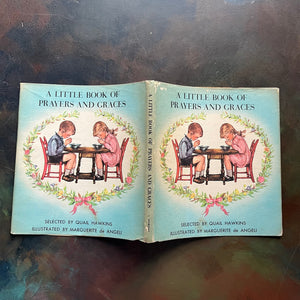 Marguerite de Angeli's A Pocket Full of Posies-A Little Book of Prayers and Graces by Quail Hawkins-first prayer book-view of the outside of the dust jacket
