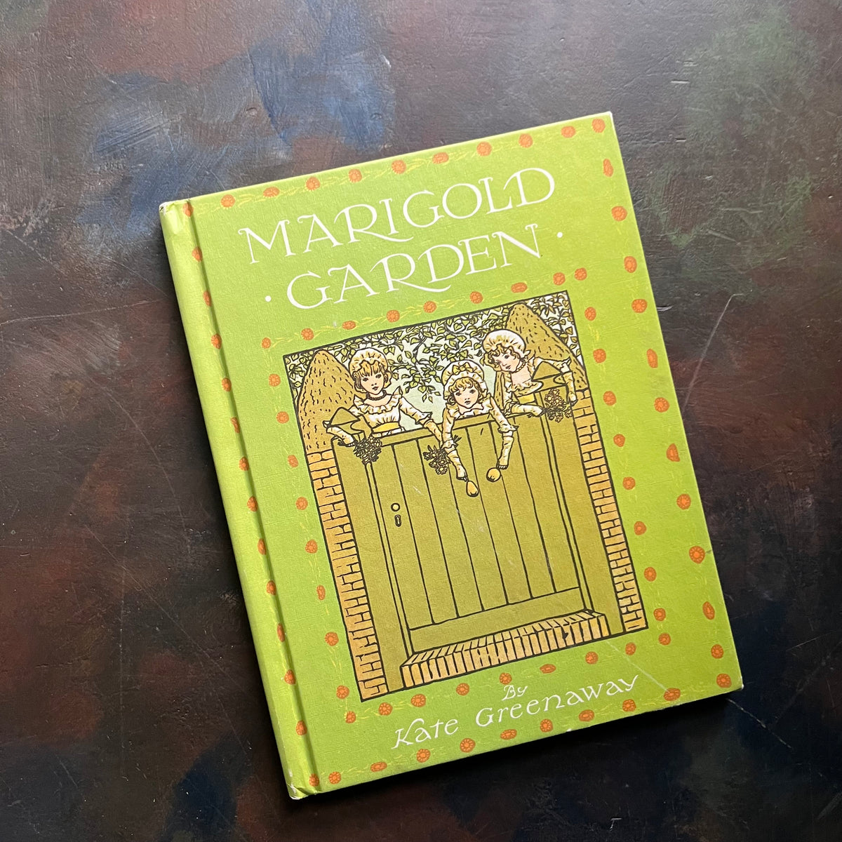 Marigold Garden Written & Illustrated by Kate Greenaway-vintage children's book of rhymes & illustrations-poetry for children-view of the front cover - which appears to be more yellow than green in the photo but the cover is green