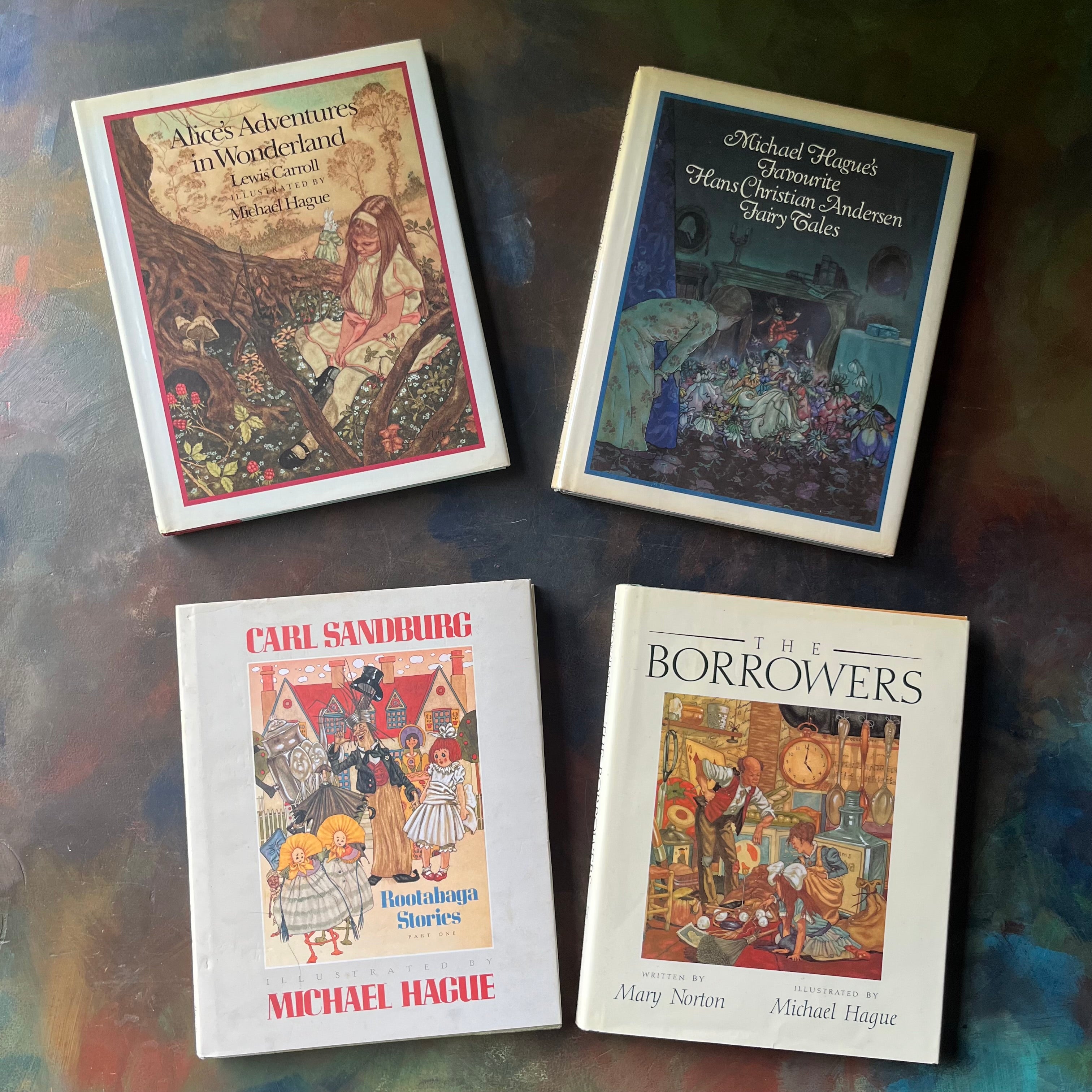 Bundle of Books illustrated by Michael Hague-Alice's Adventures in Wonderland-Michael Hague's Favourite Hans Christian Andersen's Fairy Tales-The Borrower's-Rootabaga Stories Part One-classic children's literature book set-view of the dust jacket's covers