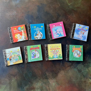 Miniature Little Golden Book Set-Christmas Editions-8 Book Set-vintage Christmas Stories-collectible children's books-view of the front covers of each book: Baby's Christmas, The Christmas Story, The Littlest Christmas Elf, The Nutcracker, The Christmas Pageant, The Twelve Days of Christmas (A Christmas Carol), Richard Scarry's Christmas Mice, and The Curious Little Kitten's First Christmas