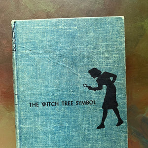 The Clue of the Broken Locket, The Clue in the Old Album, The Clue of the Leaning Chimney & The Witch Tree Symbol-view of the crease in the front cover of The Witch Tree Symbol