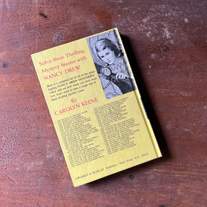 vintage children's chapter book, adventure book for girls, Nancy Drew Mystery Stories - #15 The Haunted Bridge written by Carolyn Keene - view of the back cover with the listing of the books in chronological order