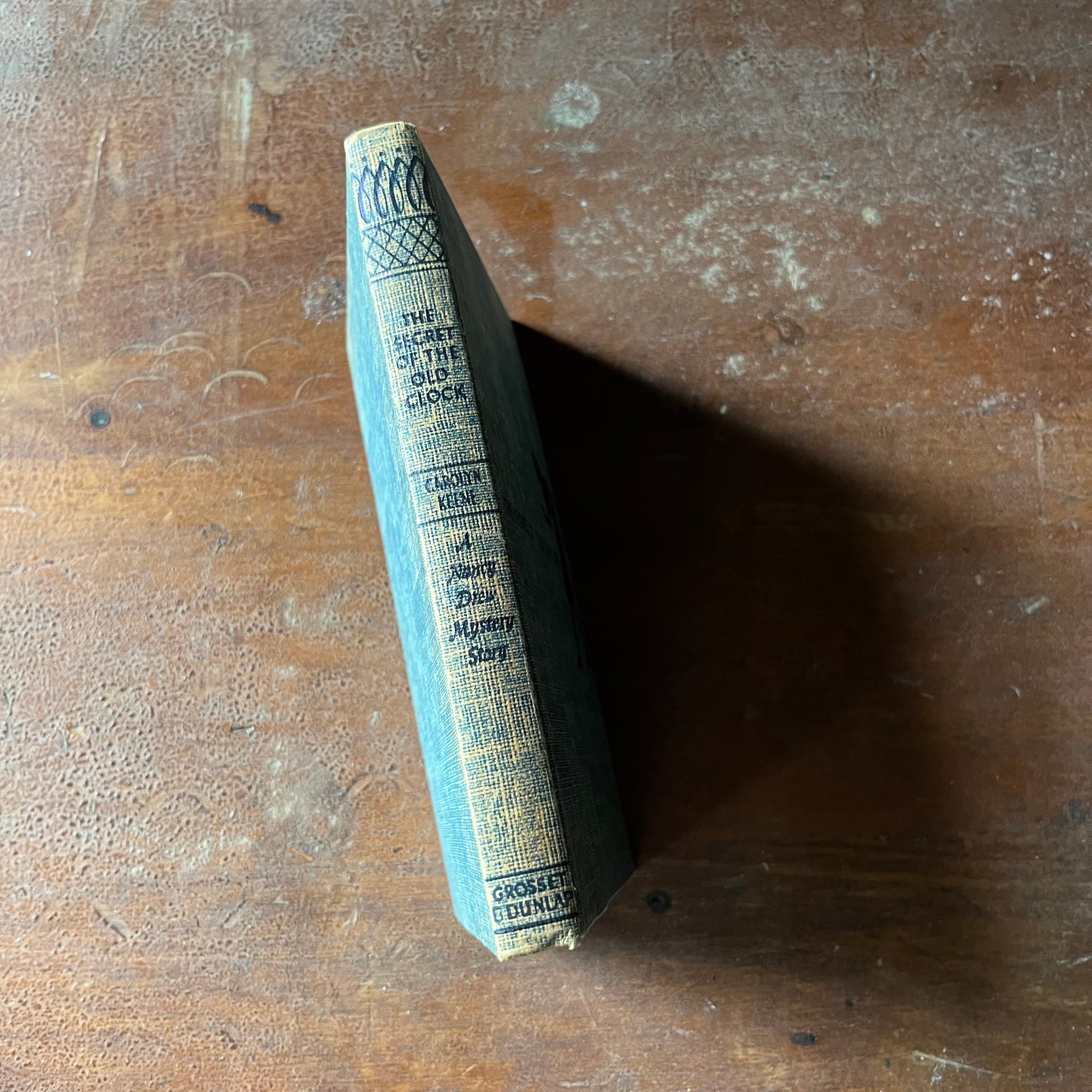 vintage children's chapter book, vintage adventure story for girls - The Nancy Drew Mystery Stories #1 The Secret of the Old Clock - Tweed Cover - written by Carolyn Keene - view of the spine