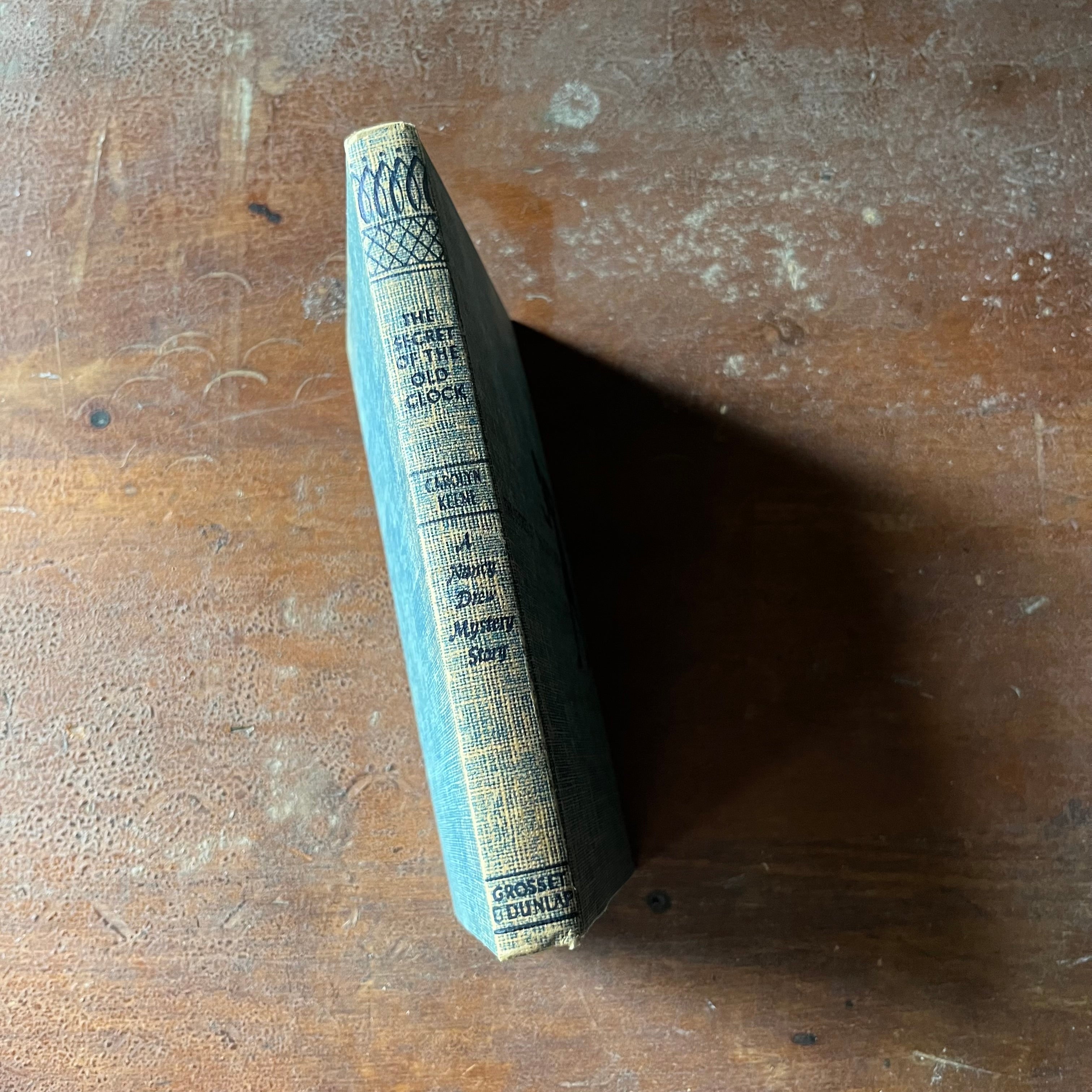 vintage children's chapter book, vintage adventure story for girls - The Nancy Drew Mystery Stories #1 The Secret of the Old Clock - Tweed Cover - written by Carolyn Keene - view of the spine
