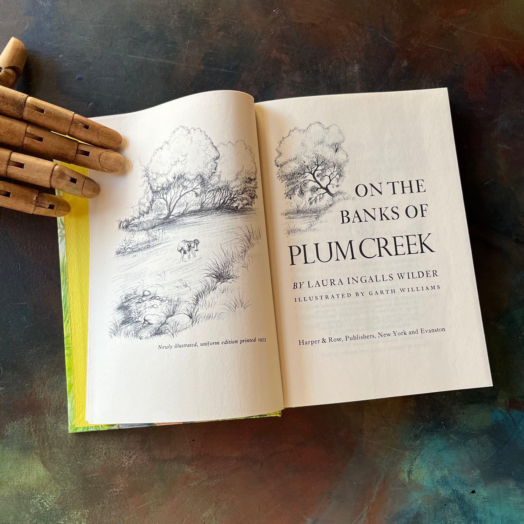 On the Banks of Plum Creek written by Laura Ingalls Wilder with illustrations by Garth Williams. This is a 1953 Edition by Harper & Row Publishers, New York & Evanston.  It was a 1938 Newbery Honor Book. 
 It is a vintage children's chapter book & living book.  View of the title page & frontispiece.
