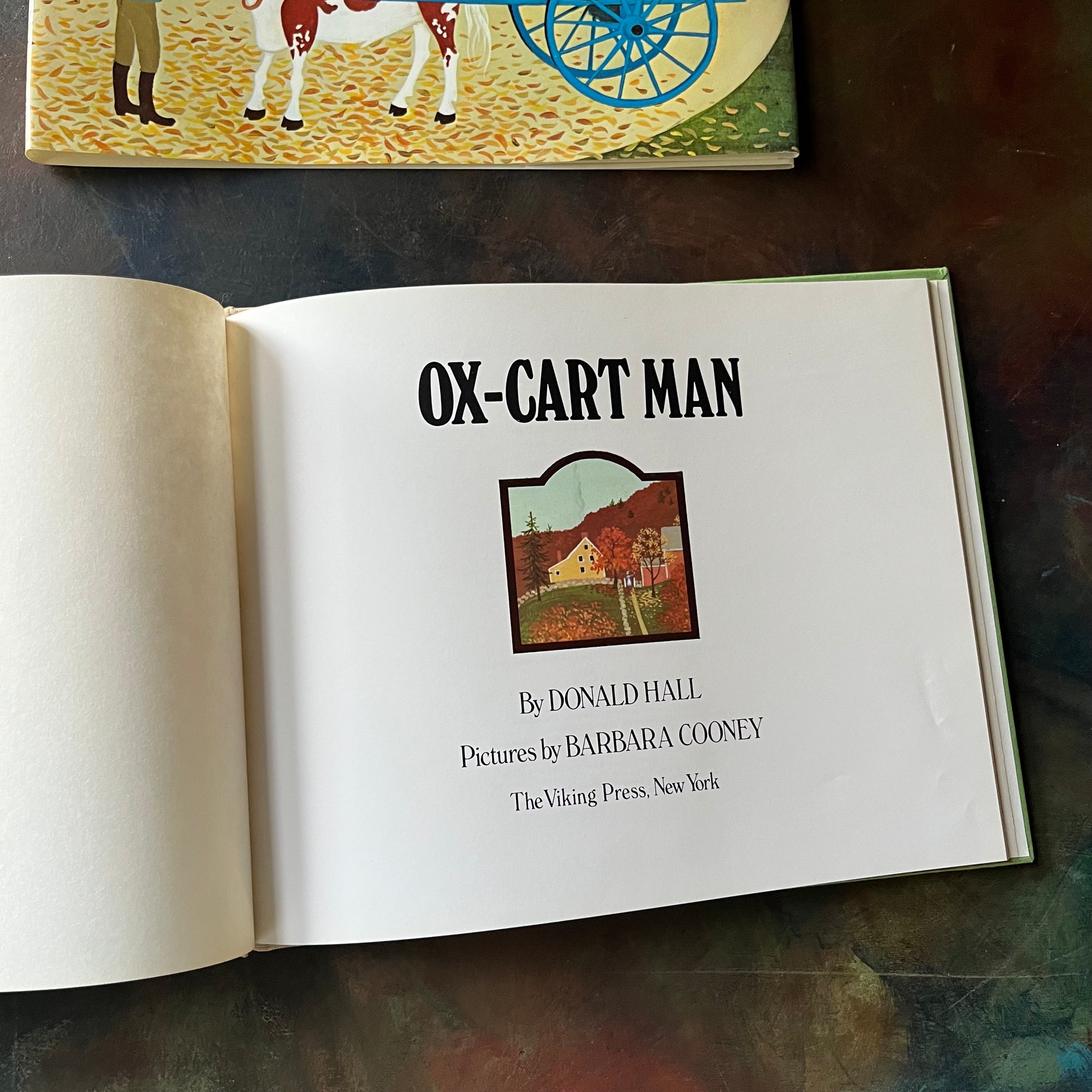 Ox-Cart Man written by Donald Hall with illustrations by Barbara Cooney-vintage children's picture book-1980 Caldecott Medal Winner-view of the title page with a colorful fall image in the middle
