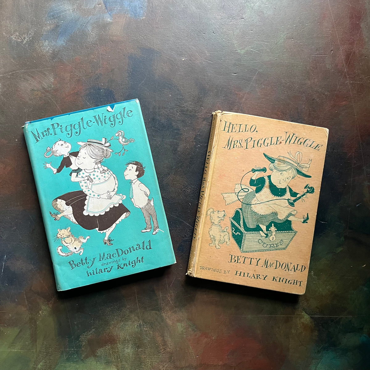 Pair of Betty MacDonald Books-Mrs. Piggle-Wiggle and Hello, Mrs. Piggle-Wiggle-illustrated by Hilary Knight-family read aloud classic children's books-vintage chapter books-humorous children's books-view of the front covers showing the dust jacket cover of Mrs. Piggle-Wiggle-images of Mrs. Piggle-Wiggle on both