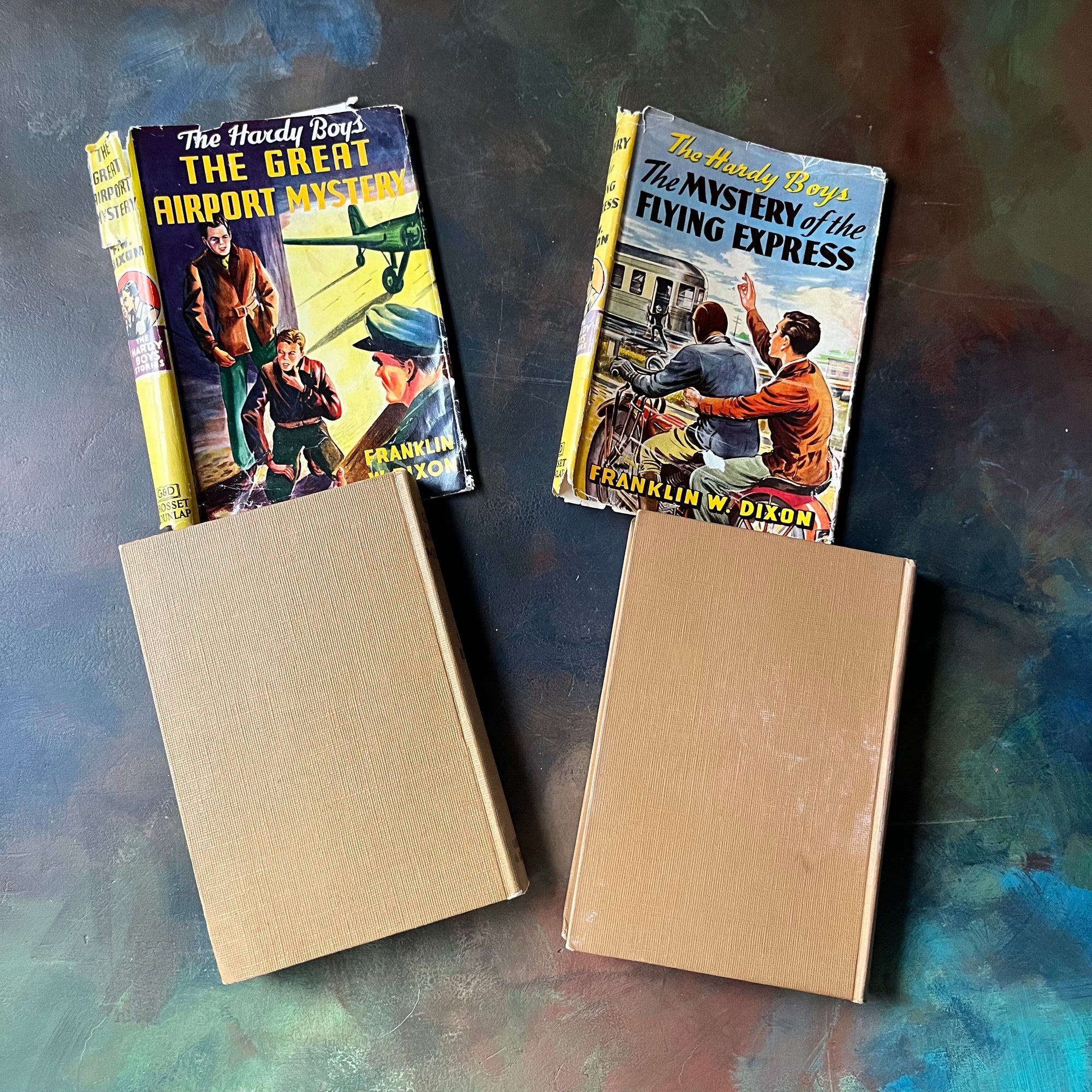 Pair of Hardy Boys Mysteries written by Franklin W. Dixon-The Great Airport Mystery-The Mystery of the Flying Express-vintage children's mysteries-view of the back covers