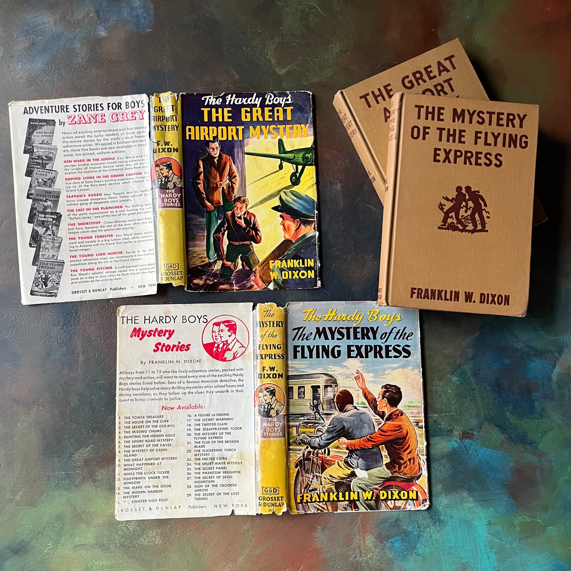 Pair of Hardy Boys Mysteries written by Franklin W. Dixon-The Great Airport Mystery-The Mystery of the Flying Express-vintage children's mysteries-view of the outside of the dust jackets
