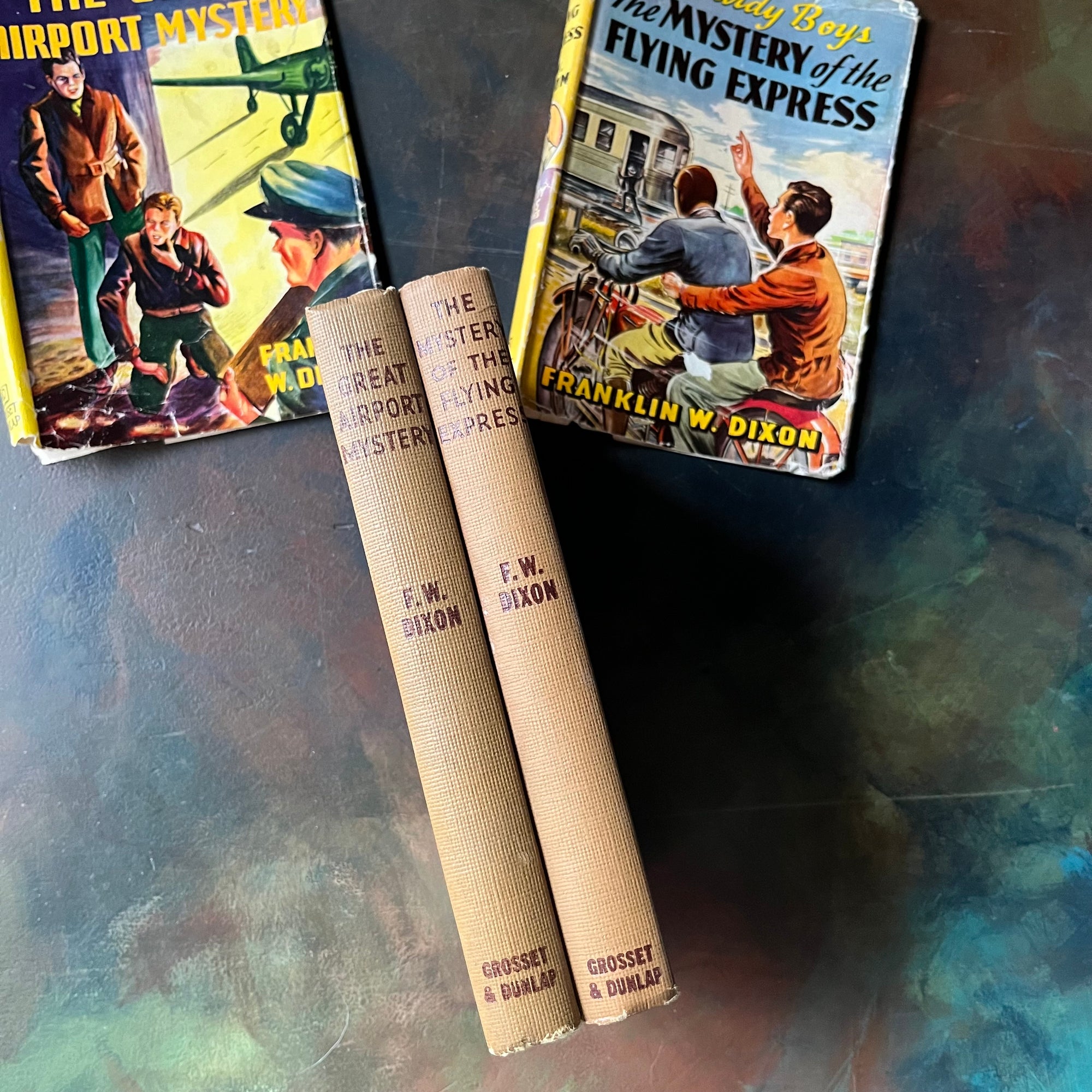 Pair of Hardy Boys Mysteries written by Franklin W. Dixon-The Great Airport Mystery-The Mystery of the Flying Express-vintage children's mysteries-view of the spines