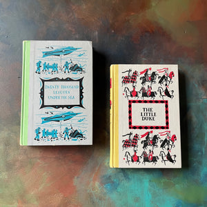 Pair of Junior Deluxe Editions Books-20,000 Leagues Under The Sea and The Little Duke-vintage children's chapter books-classic literature-view of the front covers with embossing & bright designs - each taken from illustrations within the books