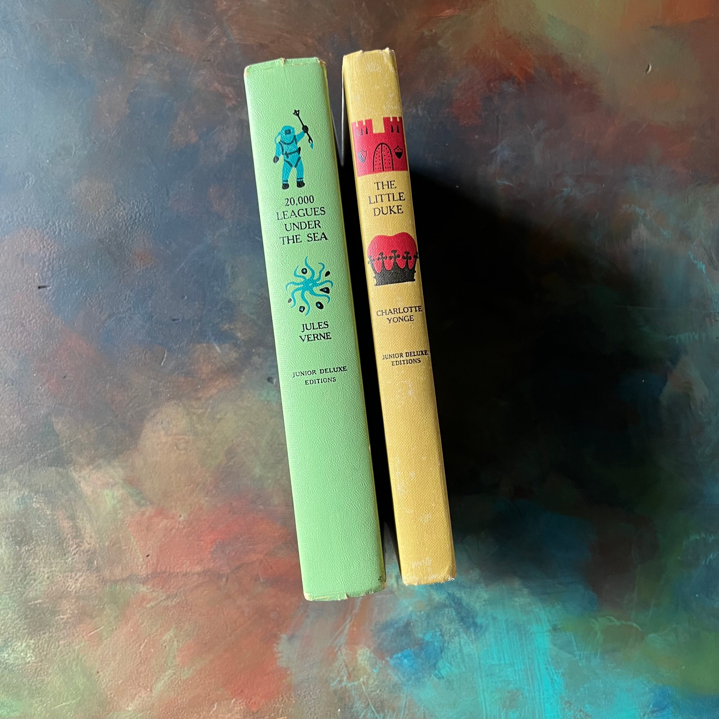 Pair of Junior Deluxe Editions Books-20,000 Leagues Under The Sea and The Little Duke-vintage children's chapter books-classic literature-view of the spines in bright colors