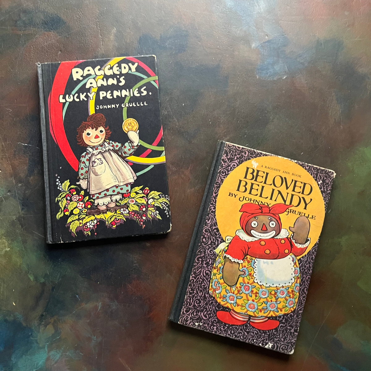 Pair of Raggedy Ann Books and Andy Books written by Johnny Gruelle-Raggedy Ann's Lucky Pennies-Beloved Belindy-classic children's books-view of the front covers