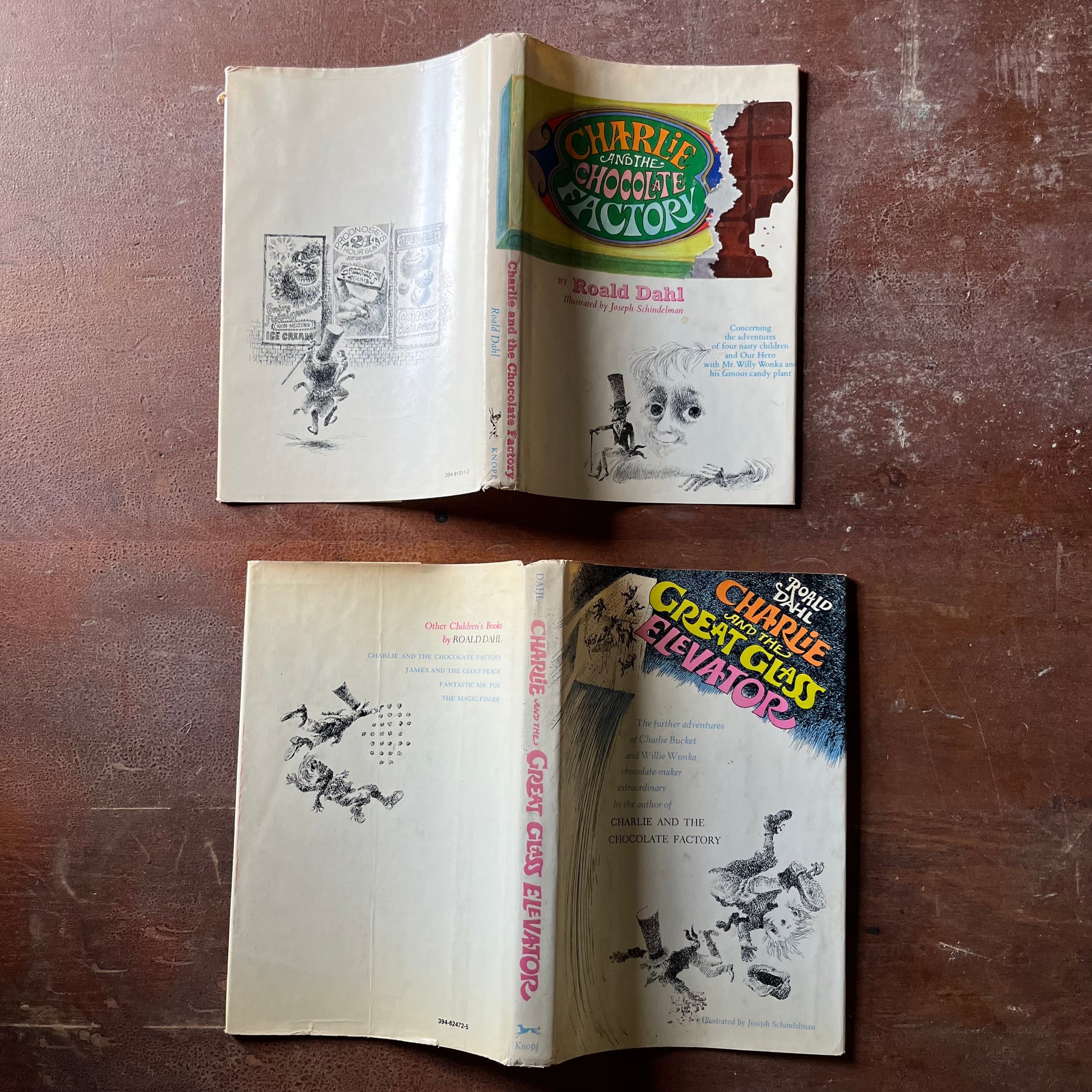 vintage children's chapter books - Pair of Roald Dahl Books-Charlie & The Chocolate Factory and Charlie & The Great Glass Elevator with illustrations by Joseph Schindelman - view of the front, spine & back view of the dust jackets