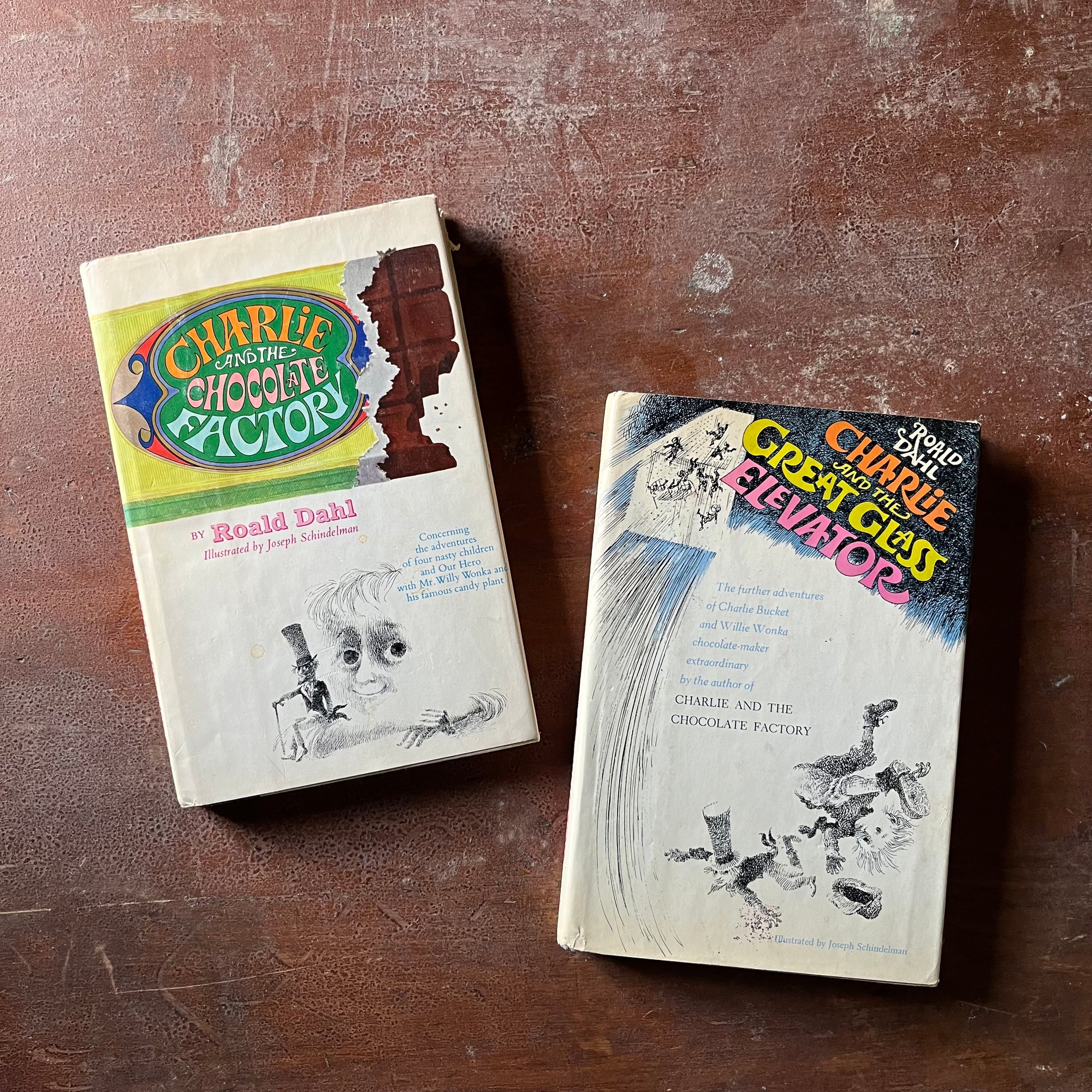 vintage children's chapter books - Pair of Roald Dahl Books-Charlie & The Chocolate Factory and Charlie & The Great Glass Elevator with illustrations by Joseph Schindelman - view of the dust jacket's front covers with illustrations from each book