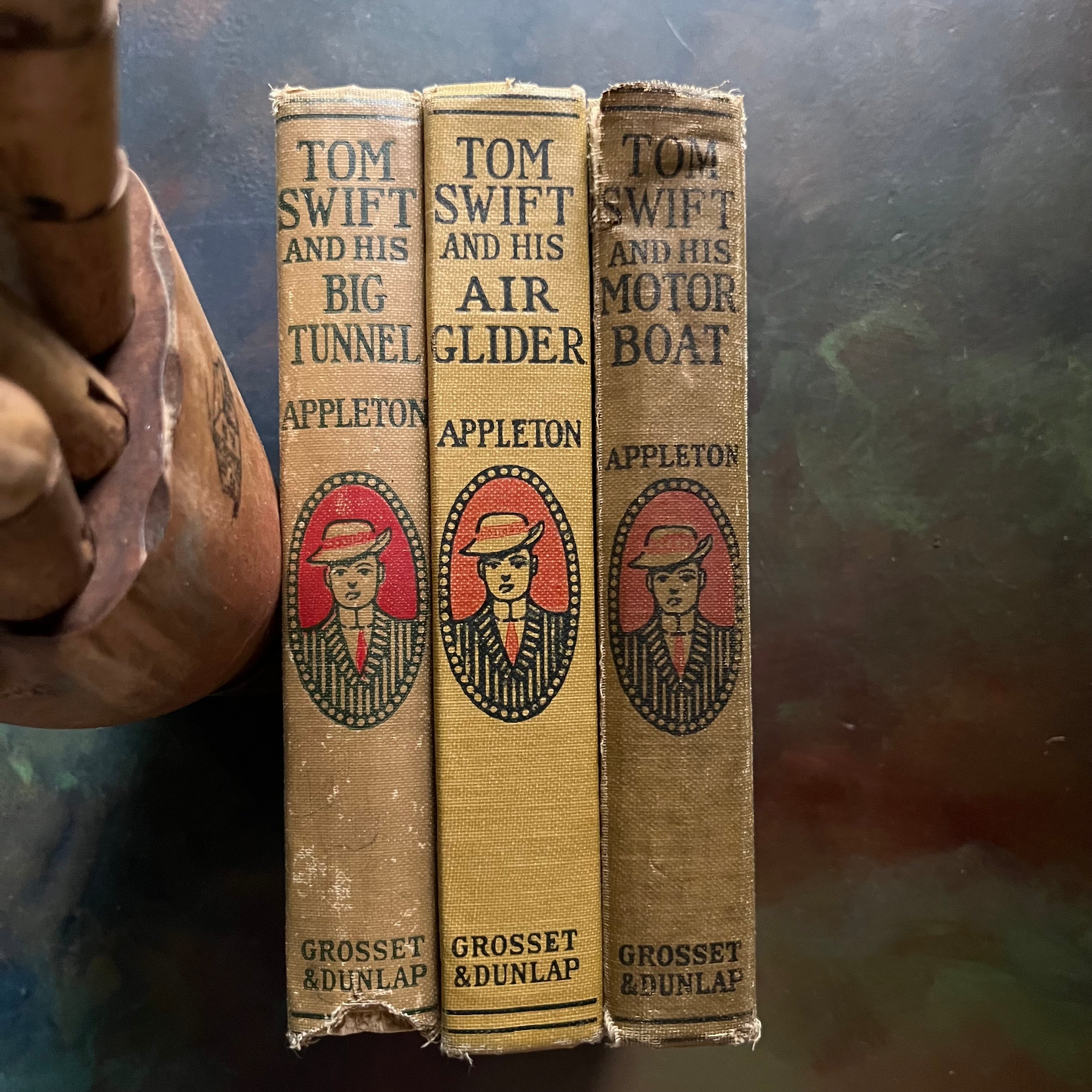 Set of Three Antique Adventure Books For Boys-Tom Swift and His Big Tunnel, Tom Swift & His Air Glider, and Tom Swift and His Motor Boat written by Victor Appleton-view of the spines