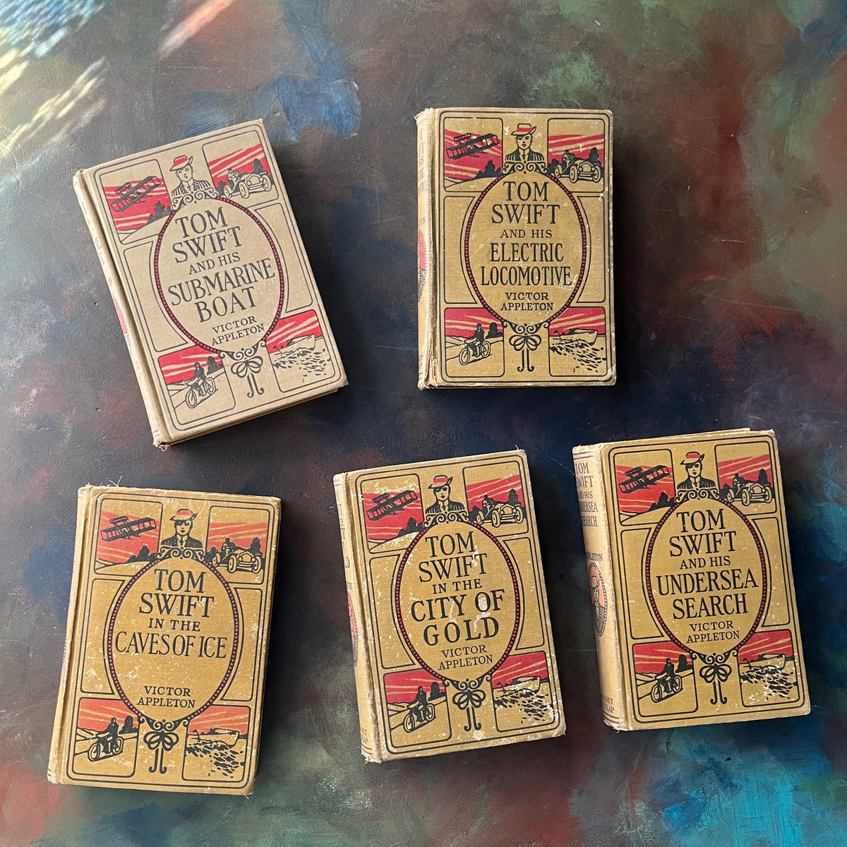 Set of 5 Antique Tom Swift Books written by Victor Appleton & Including-Submarine Boat-Electric Locomotive-Undersea Search-Caves of Ice-City of Gold-antique children's mystery books-view of the front covers