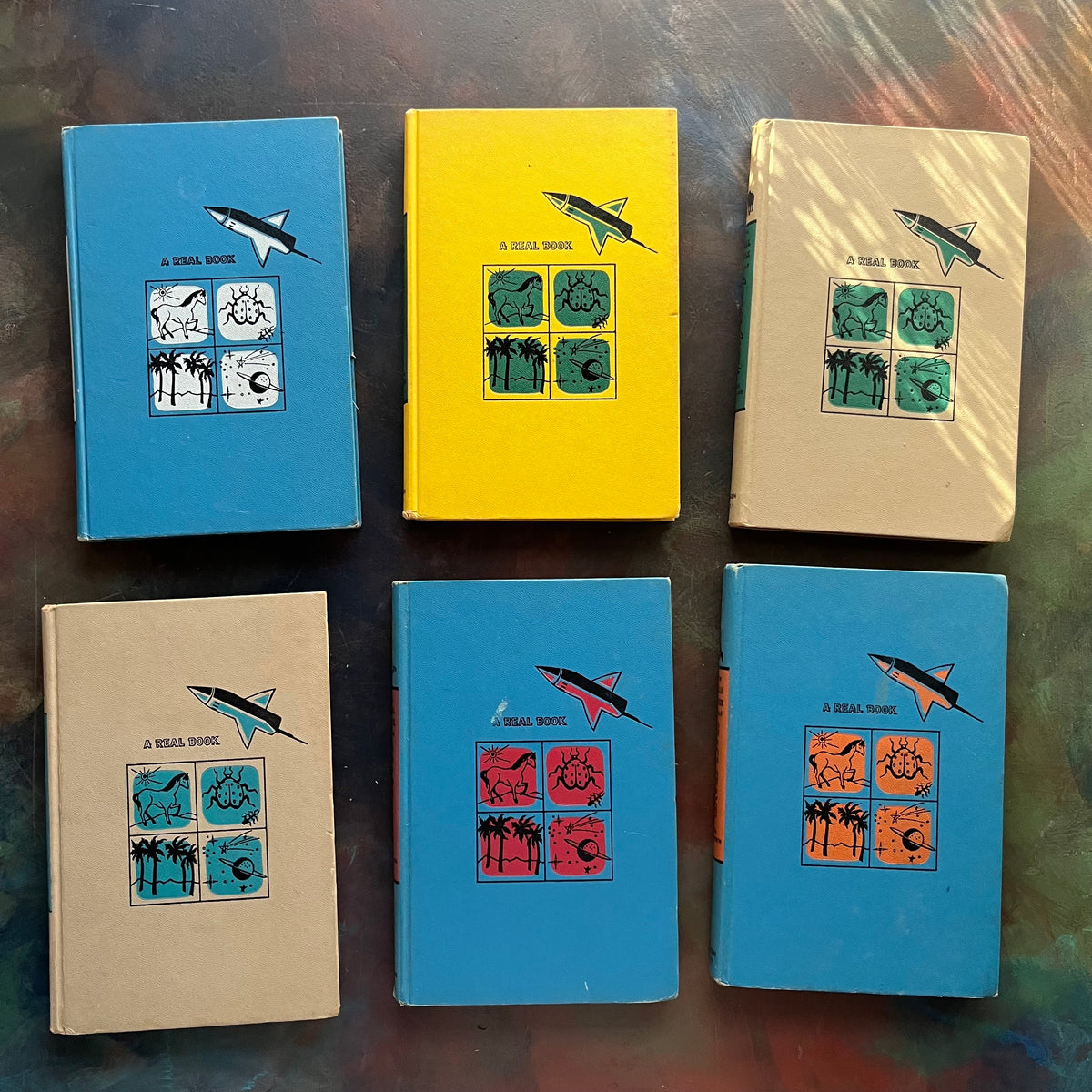 Set of 6 The Real Book About Books - Pets-Magic-Space Travel-Stars-Amazing Animals-Science Experiments-vintage children's science books-view of the front covers with the same design on each with different color schemes