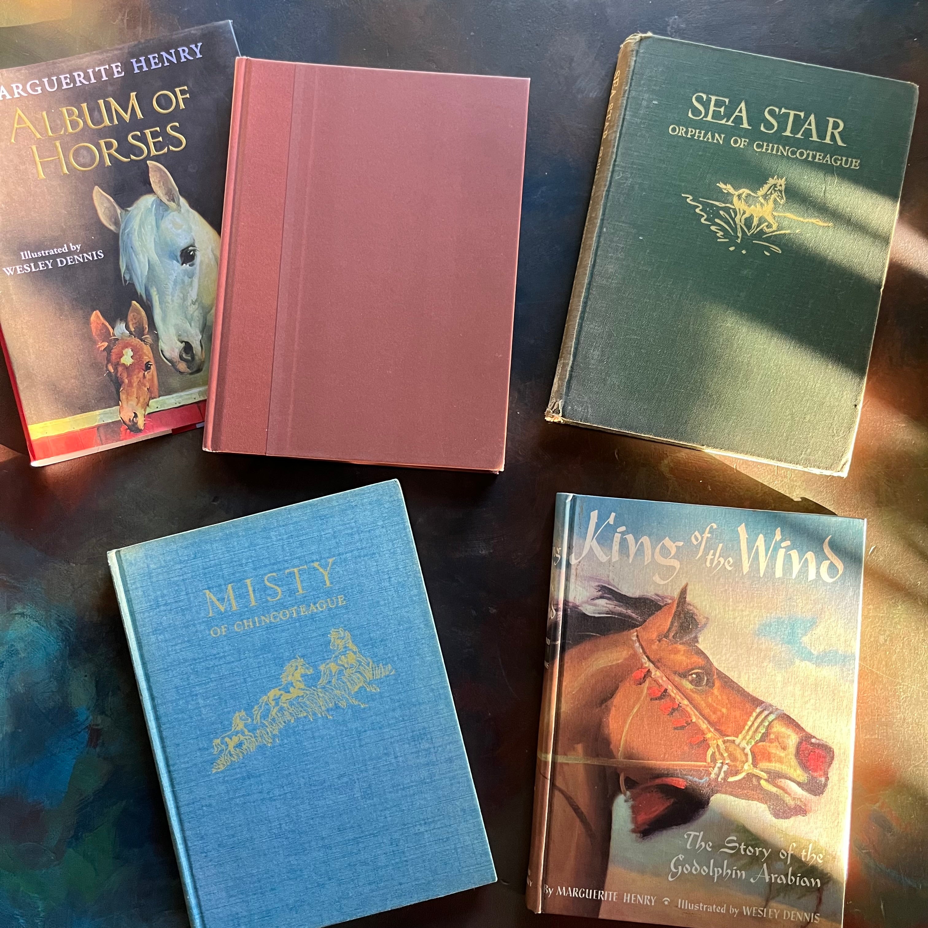 Set of Four Marguerite Henry Books-Album of Horses-King of the Wind-Sea Star-Misty of Chincoteague-vintage children's chapter books-view of the front covers minus the dust jacket