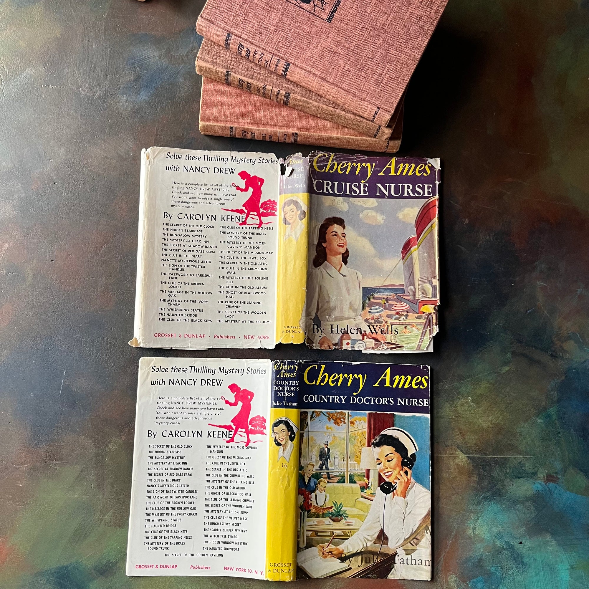 Set of Three Cherry Ames Nurse Books-vintage children's mystery books-children's chapter books-vintage mysteries-Helen Wells-Julie Tatham-view of the outside of the dust jackets - note the wear to Cherry Ames Cruise Nurse
