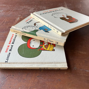 Set of Three Dick Druna Books-Dick Druna's Cinderella, Dick Druna's Tom Thumb & Dick Druna's Little Red Riding Hood-vintage fairy tales-view of the books on their sides showing their spines & part of their front covers