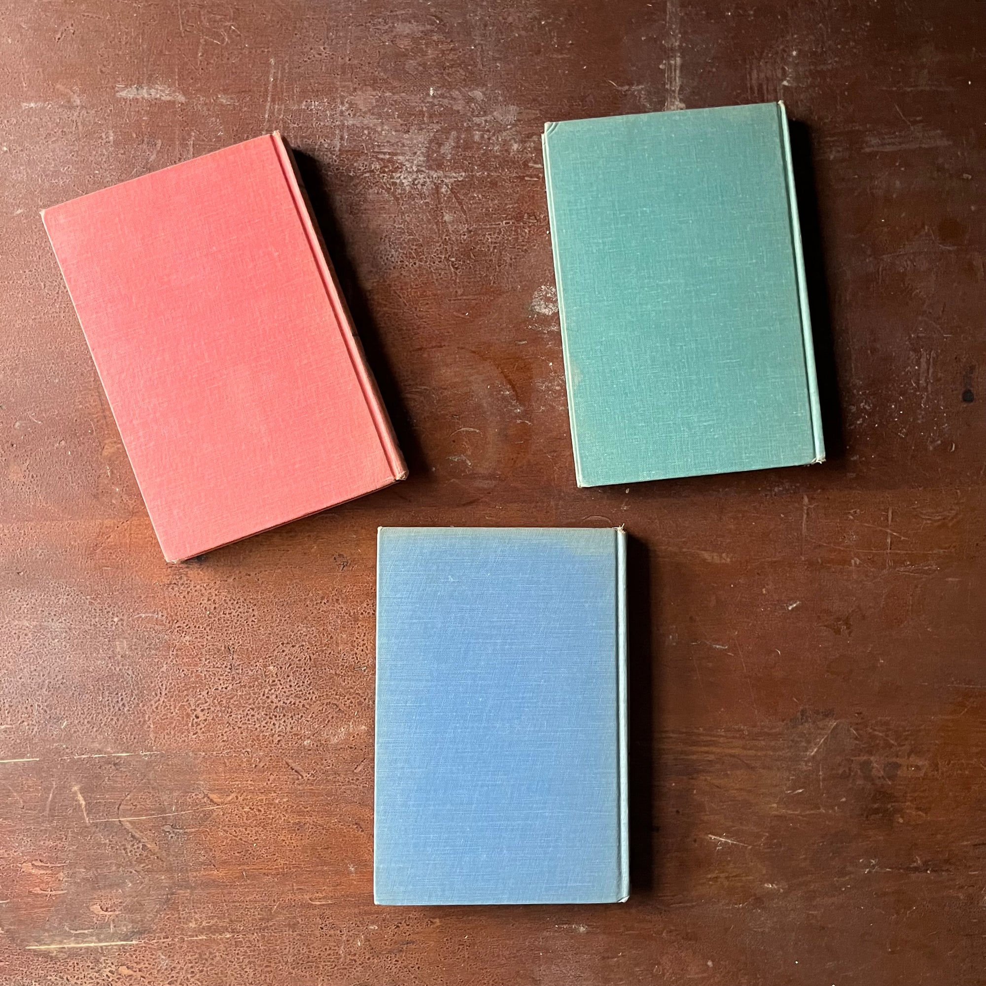 vintage children's history books - Set of Three Landmark Series Books-Ferdinand Magellan, The Louisiana Purchase & The Pony Express - view of the colorful back covers in pink, green & blue