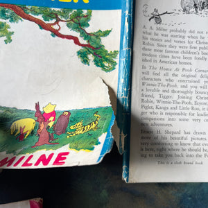 Set of Three Vintage Children's Books Written by A. A. Milne-Winnie The Pooh-The House at Pooh Corner-When We Were Very Young-view of a tear in the dust jacket's cover of the House at Pooh Corner