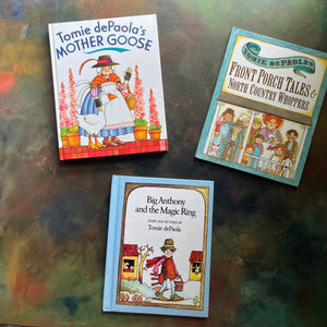 Set of Picture Books written and illustrated by Tomie DePaola -Front Porch Tales & North Country Whoppers-Big Anthony and the Magic Ring-Mother Goose-classic children's stories-view of the front covers with images from each book illustrated on the cover below the title
