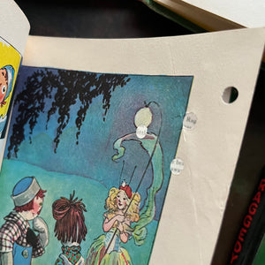 Set of four Raggedy Ann and Andy books written and illustrated by Johnny Gruelle-classic children's stories-heartwarming stories for children-view of the condition of the page with the small hole punches.