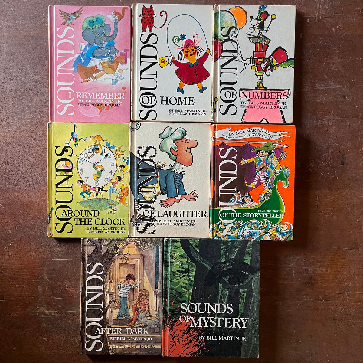 vintage children's school reading textbooks - Sounds of Language Readers written by Bill Martin, Jr. in collaboration with Peggy Brogan - set of 8 books - view of the colorful front covers with whimsical illustrations on each one