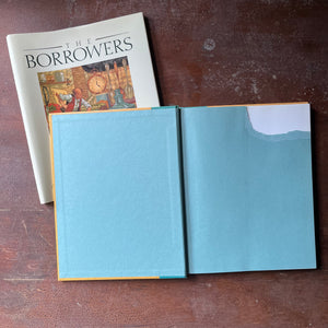 vintage children's chapter book, classic children's story, modern children's book edition - The Borrower's written by Mary Norton with illustrations by Michael Hague - view of the inside cover with the top right-hand section torn away to remove a name & address or inscription