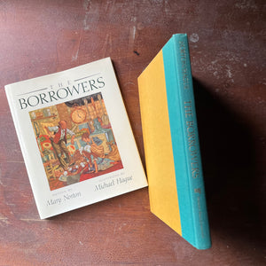 vintage children's chapter book, classic children's story, modern children's book edition - The Borrower's written by Mary Norton with illustrations by Michael Hague - view of the embossed spine in bright blue with gold lettering