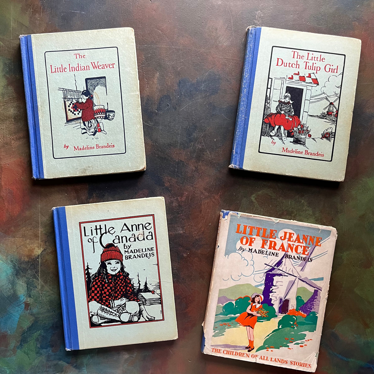 Set of Four The Children of All Lands Stories Books -Little Indian Weaver-The Little Dutch Tulip Girl-Little Anne of Canada-Little Jeanne of France-living history books-view of the front covers showing Little Jeanne's dust jacket cover