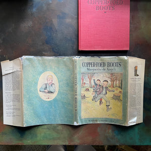 The Copper-Toed Boots written and illustrated by Marguerite de Angeli-first edition-vintage children's biography-chapter book-view of the entire outside of the dust jacket showing condition - wear around the edges as well as showing the inside flaps