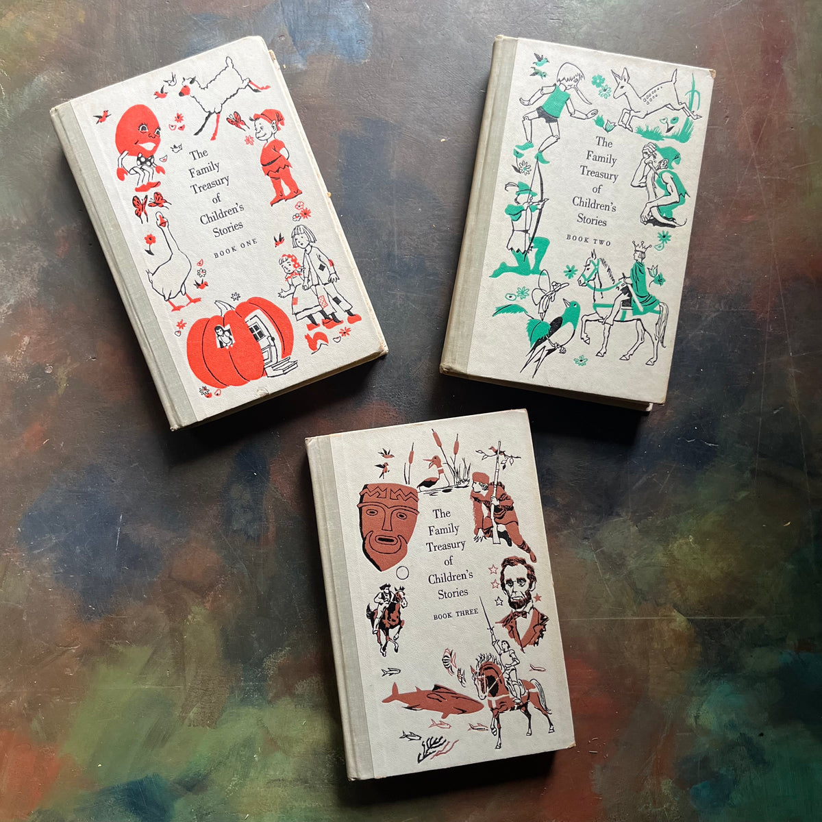 The Family Treasury of Children’s Stories-3 Volume Set-Junior Deluxe Editions-vintage children's stories-edited by Pauline Rush Evans with illustrations by Donald Sibley-view of the front covers with images from each volume on the covers along with the title of the series