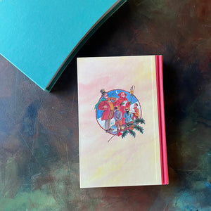 The Folio Christmas Book by The Folio Society of London-A Collection of Seasonal Stories and Poems-classic Christmas Stories & Poems-view of the back cover with an image of carolers in the center circle