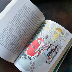 The Folio Christmas Book by The Folio Society of London-A Collection of Seasonal Stories and Poems-classic Christmas Stories & Poems-view of another full-page, full-color illustration - this one of a Santa holding a little girl with a poodle in the foreground