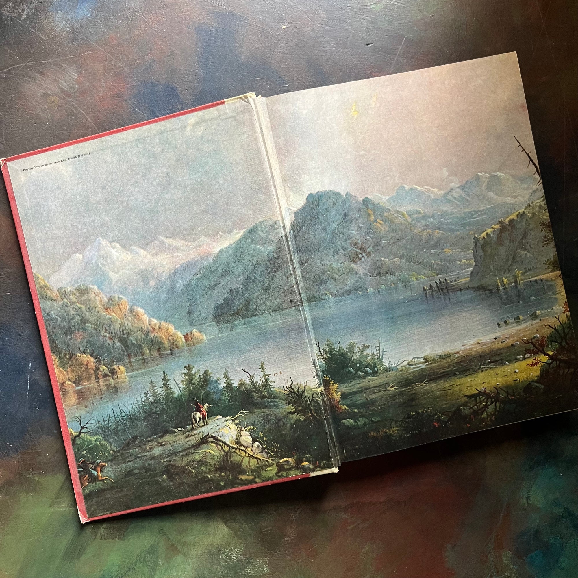 The Golden Book of America-Stories from our Country's Past-Heritage Magazine-US History for Children-America250-view of the inside cover depicting a lake scene with mountains in the background