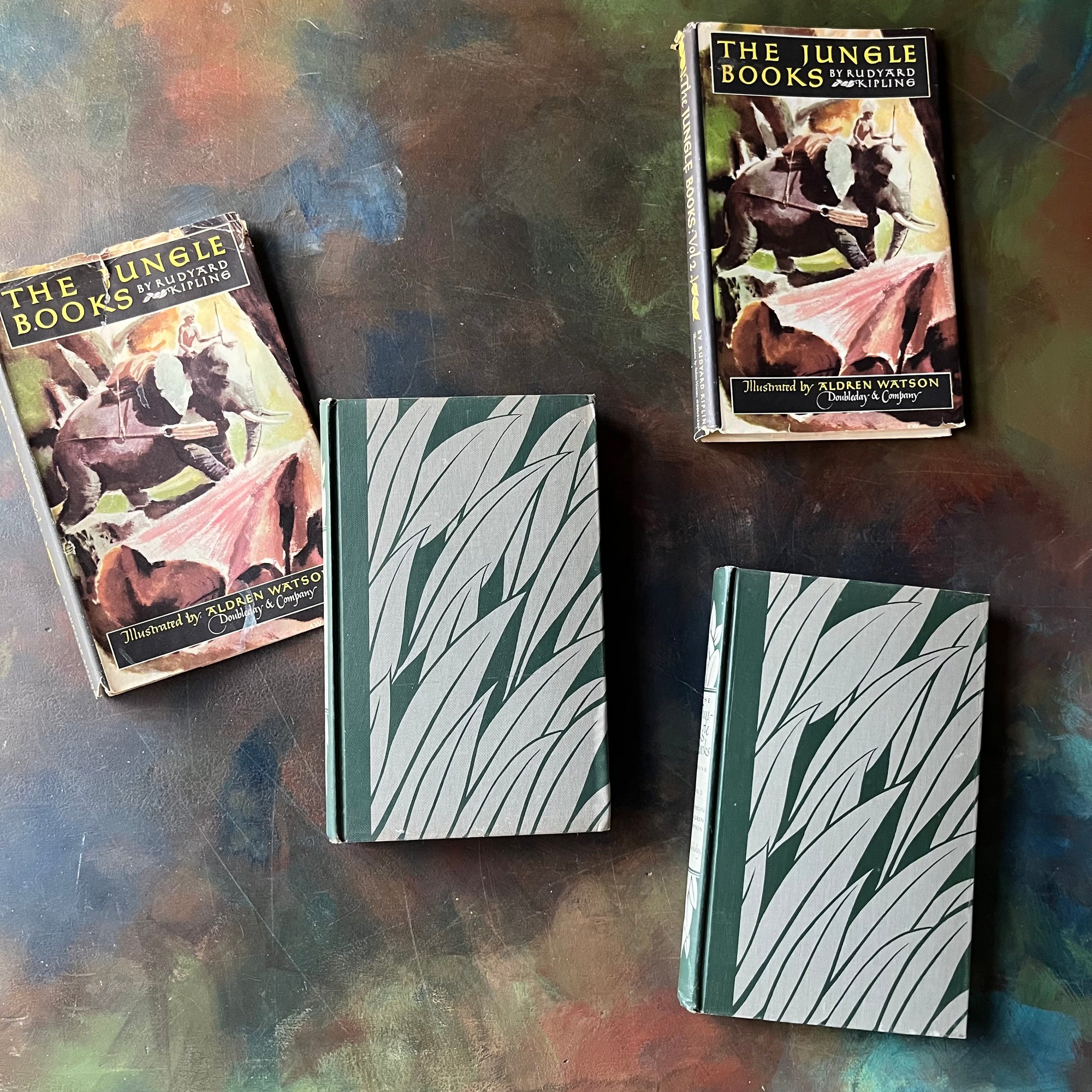 The Jungle Books by Rudyard Kipling Volumes I & II-Junior Illustrated Library Editions-vintage children's classics-view of the front covers in green & gray design with grass or leaves