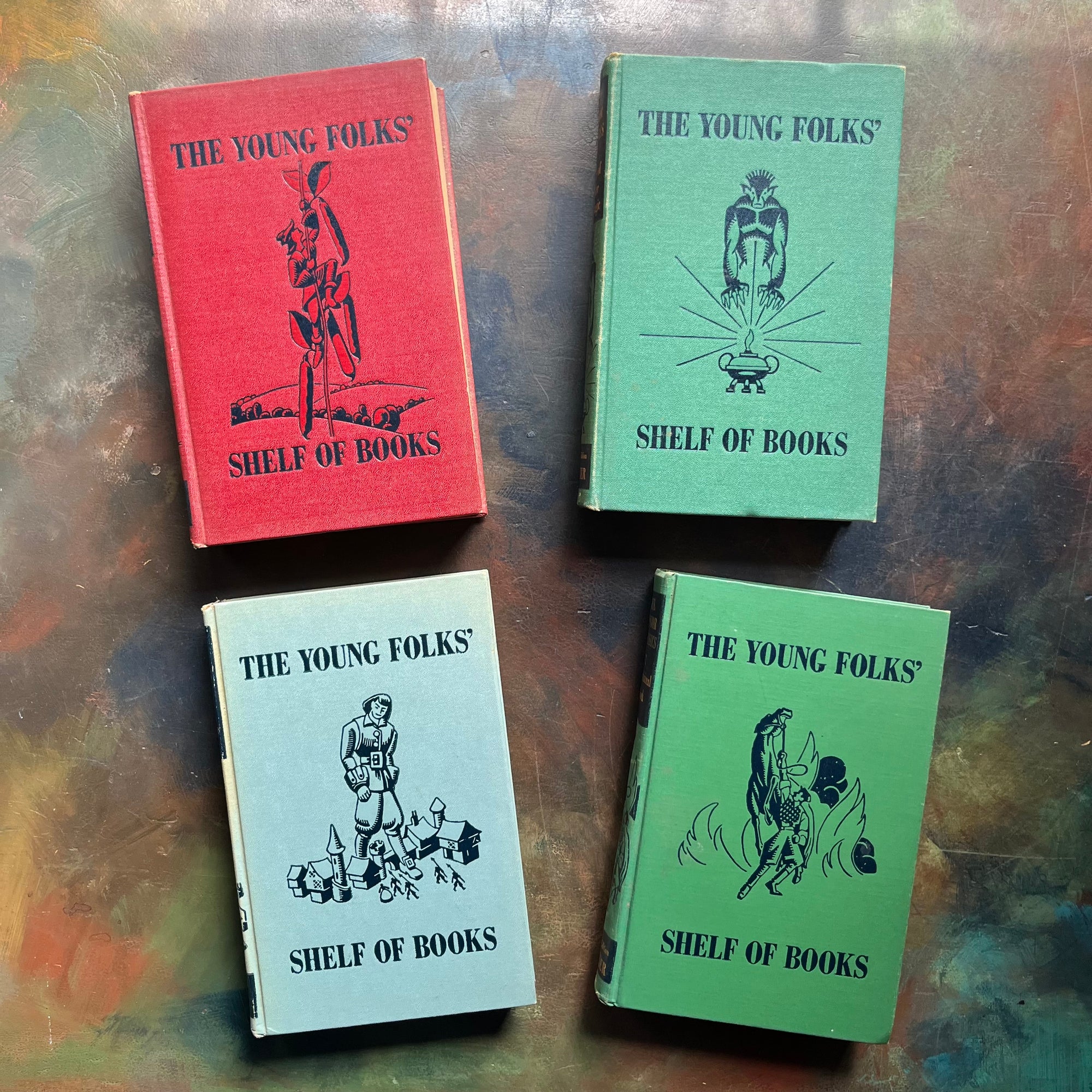 The Junior Classics Young Folks Shelf of Books-Volumes 1, 2, 5, 7-classic children's literature-anthology for children-short stories-view of the front covers with the same images as the spines depicting in the middle of the cover with "The Young Folks' Shelf of Books" written above and below the image