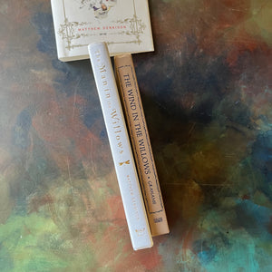 Pair of Kenneth Grahame Books: The Man in the Willows: The Life of Kenneth Grahame and The Wind in the Willows written by Kenneth Grahame & Illustrated by Tasha Tudor-view of the spines