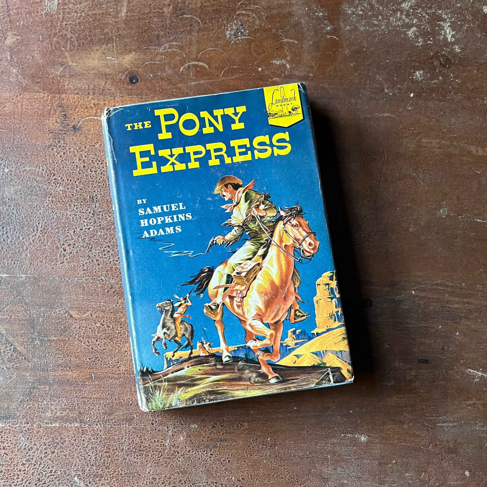 Log Cabin Vintage - vintage children's books, living history books, Landmark Series Book - The Pony Express written by Samuel Hopkins Adams with illustrations by Lee J. Ames - view of the dust jacket's front cover depicting a pony express rider being chase by Indians