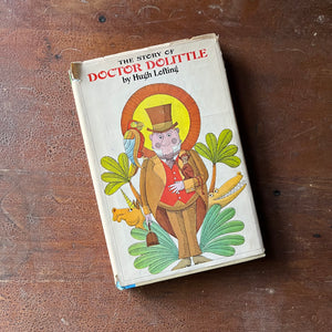 vintage children's chapter book, Junior Deluxe Editions Book - The Story of Doctor Dolittle written by Hugh Lofting with illustrations by Murray Tinkelman - view of the dust jacket's front cover with an illustration of Doctor Dolittle & a few of his animals