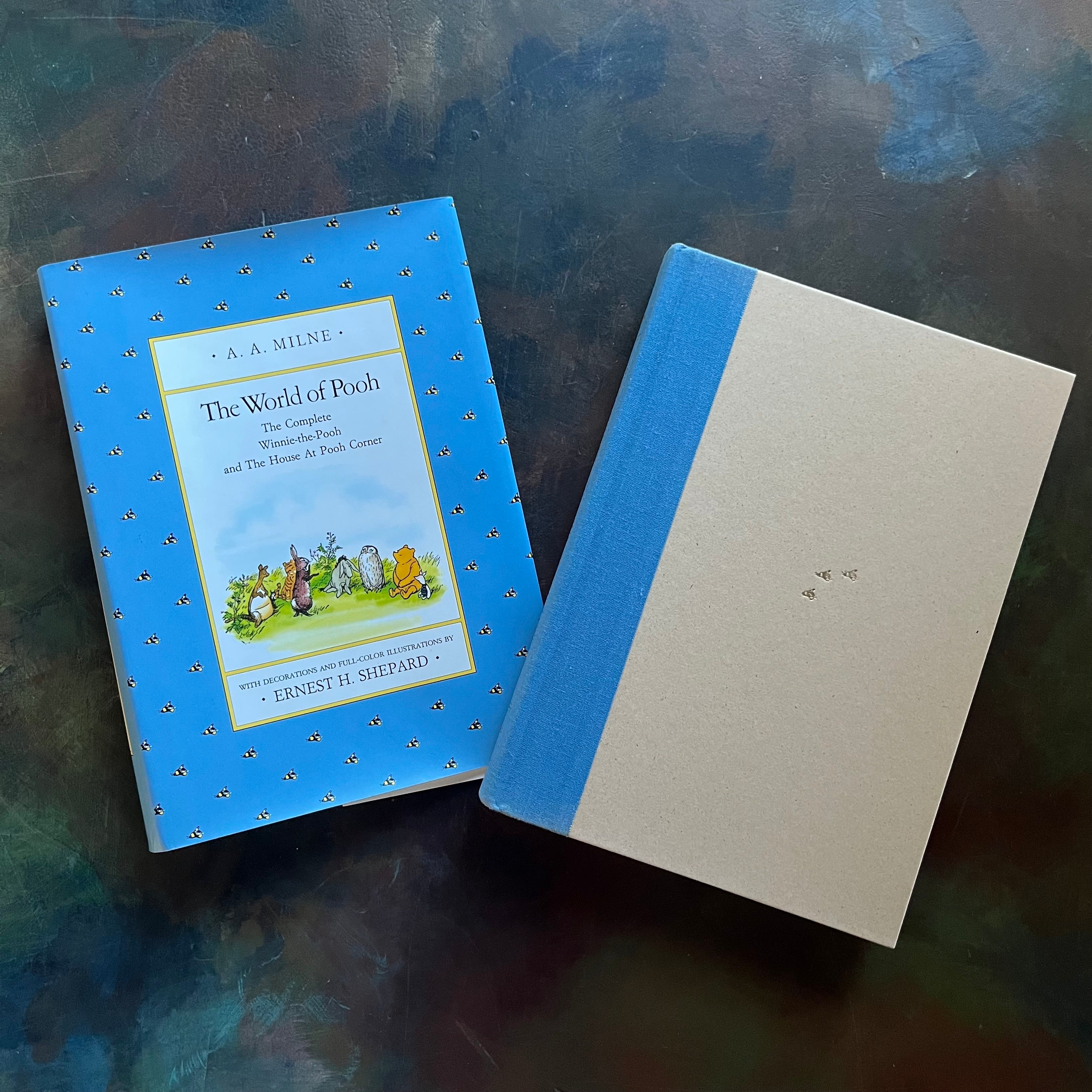 The World of Pooh-The Complete Winnie the Pooh and The House at Pooh Corner-A. A. Milne-E. H. Shepard-Read Aloud Revival-vintage children's short stories-view of the clothbound front cover with three little bees embossed in a gold coloring in the middle