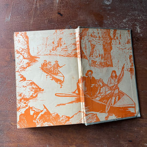 vintage children's chapter book, adventure books for boys - The Young Mineralogist: The Jaws of Death written by Edwin J. Houston - view of the back, inside cover with an illustration of two canoes in what appears to be a canyon