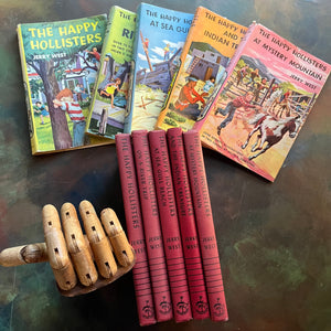 The Happy Hollisters Mystery Series by Jerry West-Starter Set Books 1-5-vintage children's mystery books-wholesome family reads-view of the spines with the dust jackets in the background
