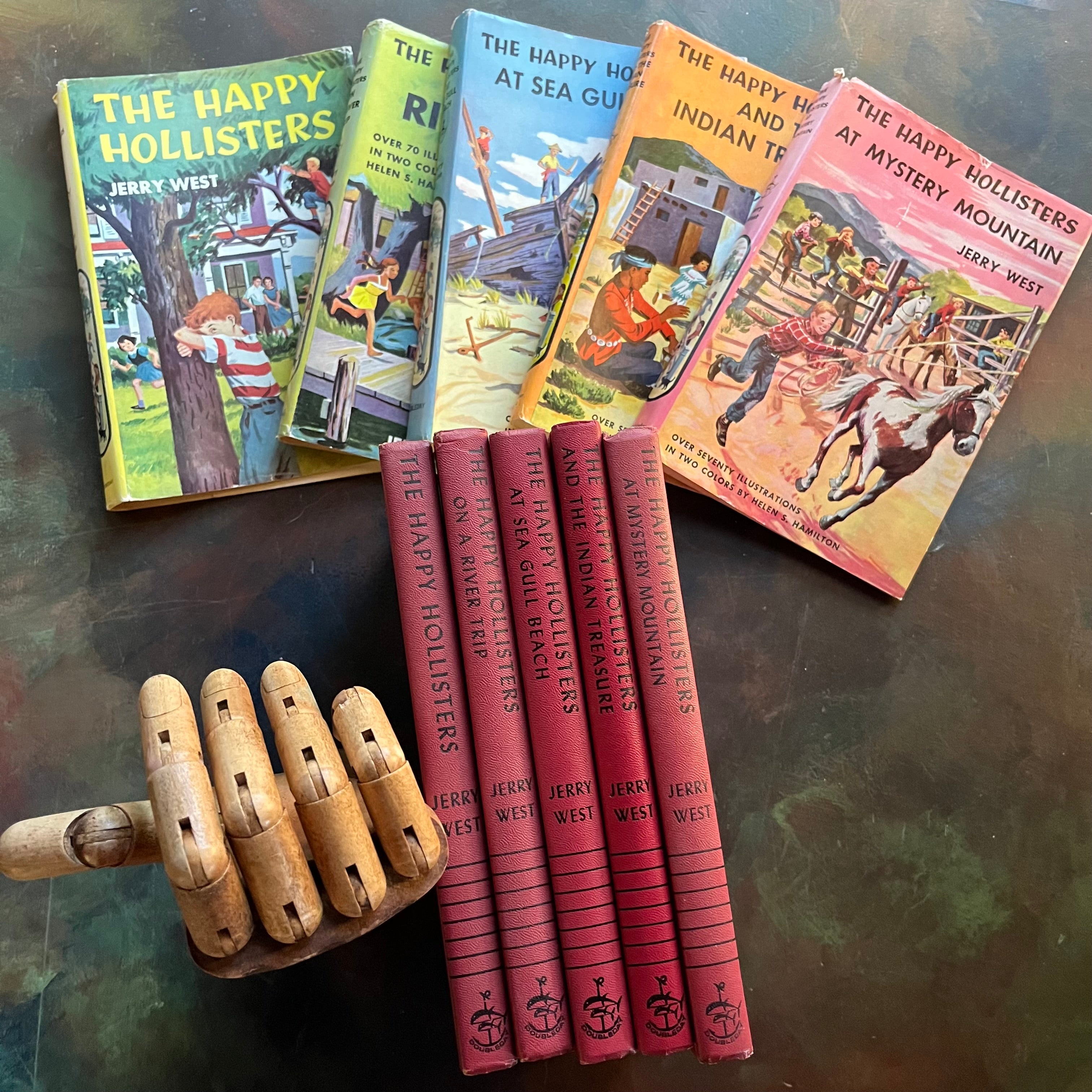 The Happy Hollisters Mystery Series by Jerry West-Starter Set Books 1-5-vintage children's mystery books-wholesome family reads-view of the spines with the dust jackets in the background